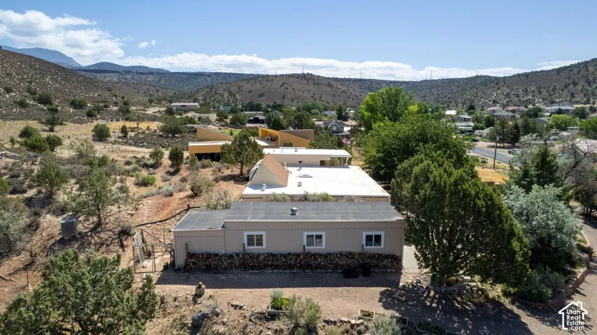 Single-story property featuring a neutral exterior, multiple windows, and a flat roofline