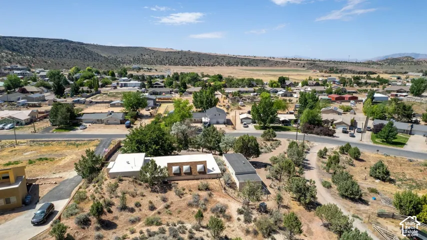 Expansive aerial perspective showcasing a residential community nestled within a valley landscape
