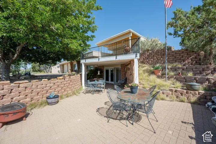 Expansive brick paver patio featuring a tiered retaining wall system