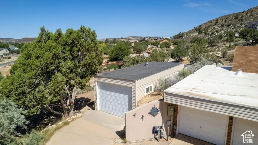 Two separate garage structures featuring overhead doors and horizontal siding