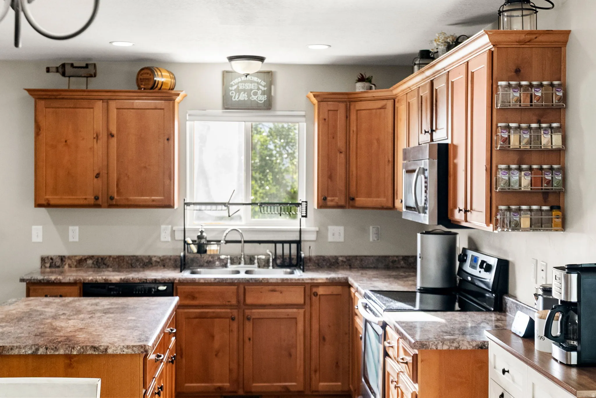 Kitchen featuring light wood cabinetry, stone-look countertops, and recessed lighting