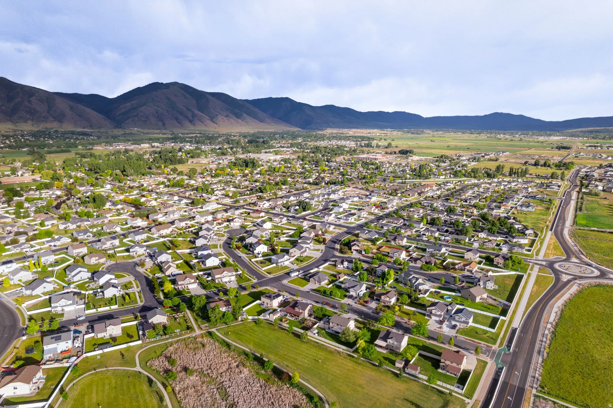 Expansive aerial view showcasing a developed residential community with diverse housing styles