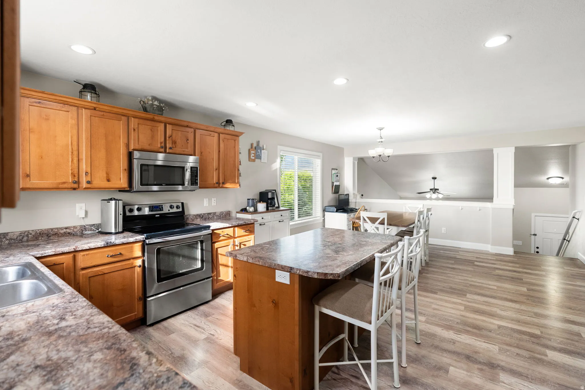 Kitchen featuring wood cabinetry, stainless steel appliances, and a double basin sink