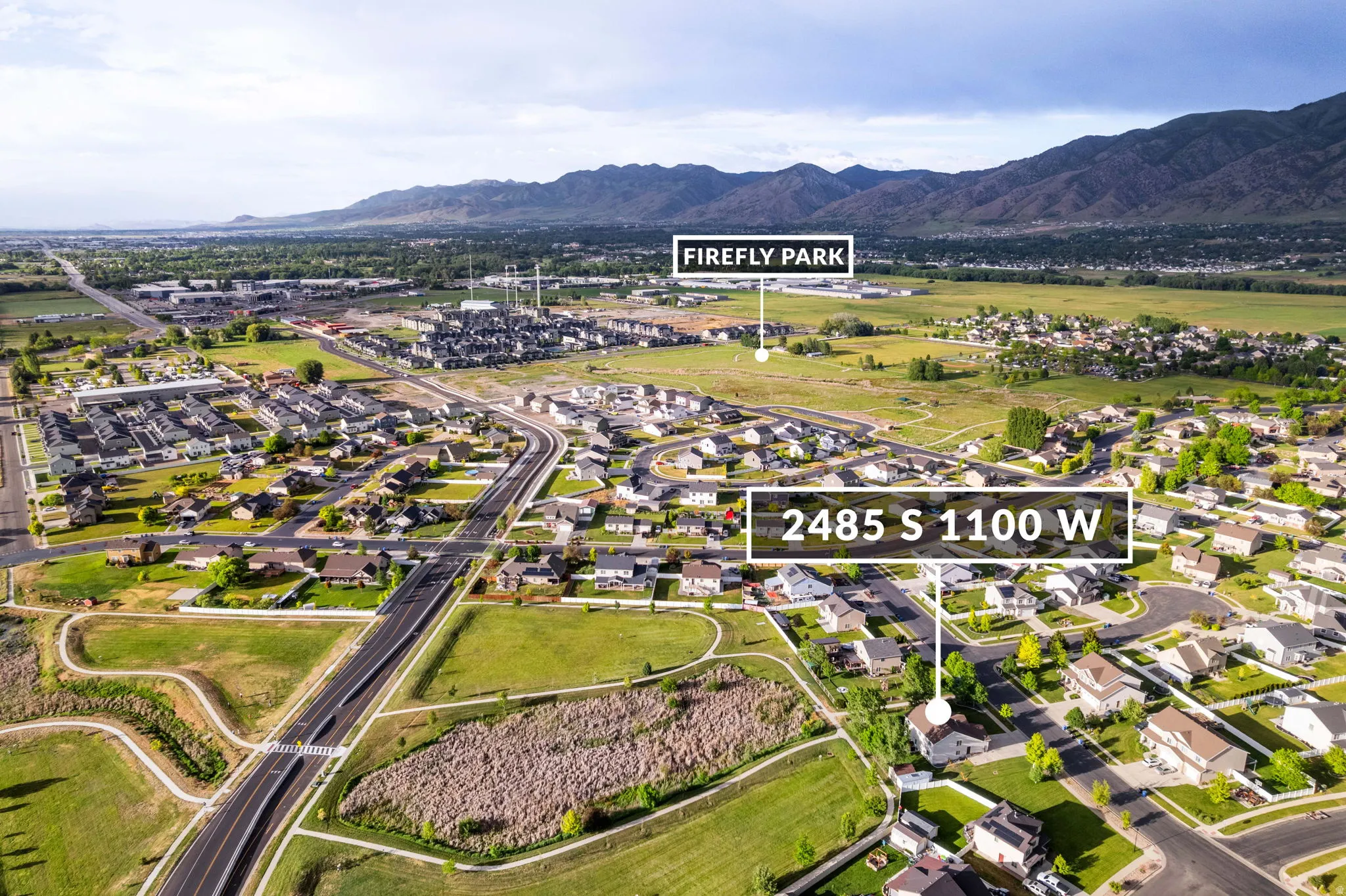 Aerial perspective showcasing a residential neighborhood with distant mountain ranges