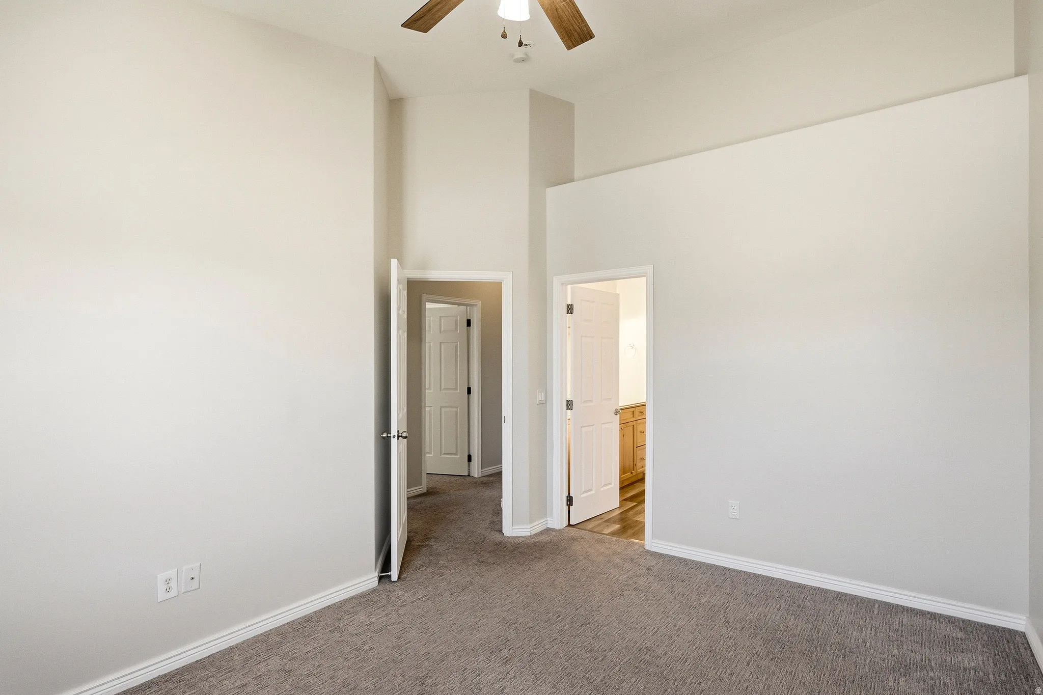 Interior room featuring vaulted ceilings and a ceiling fan
