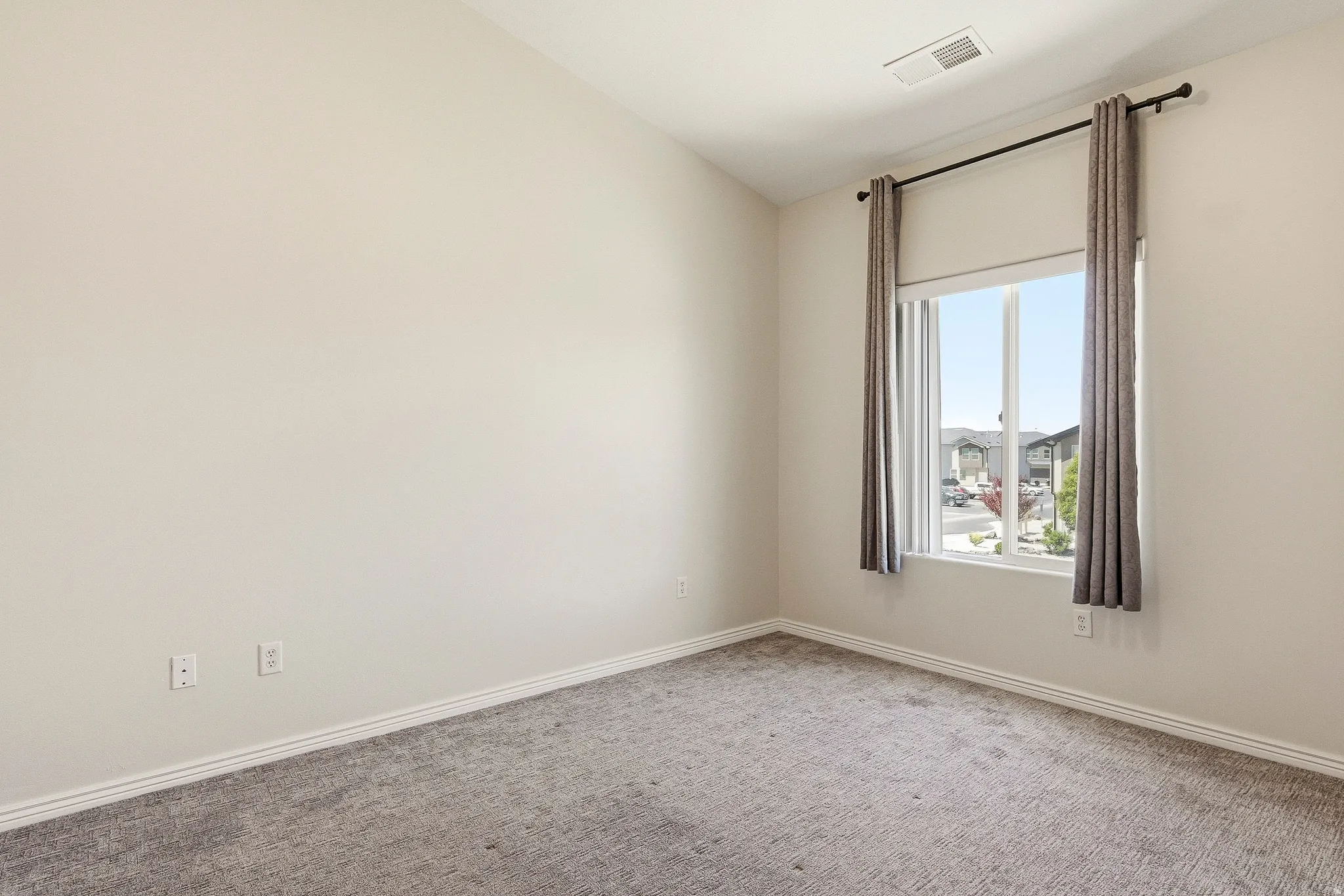 Neutral-toned carpeting paired with light wall paint