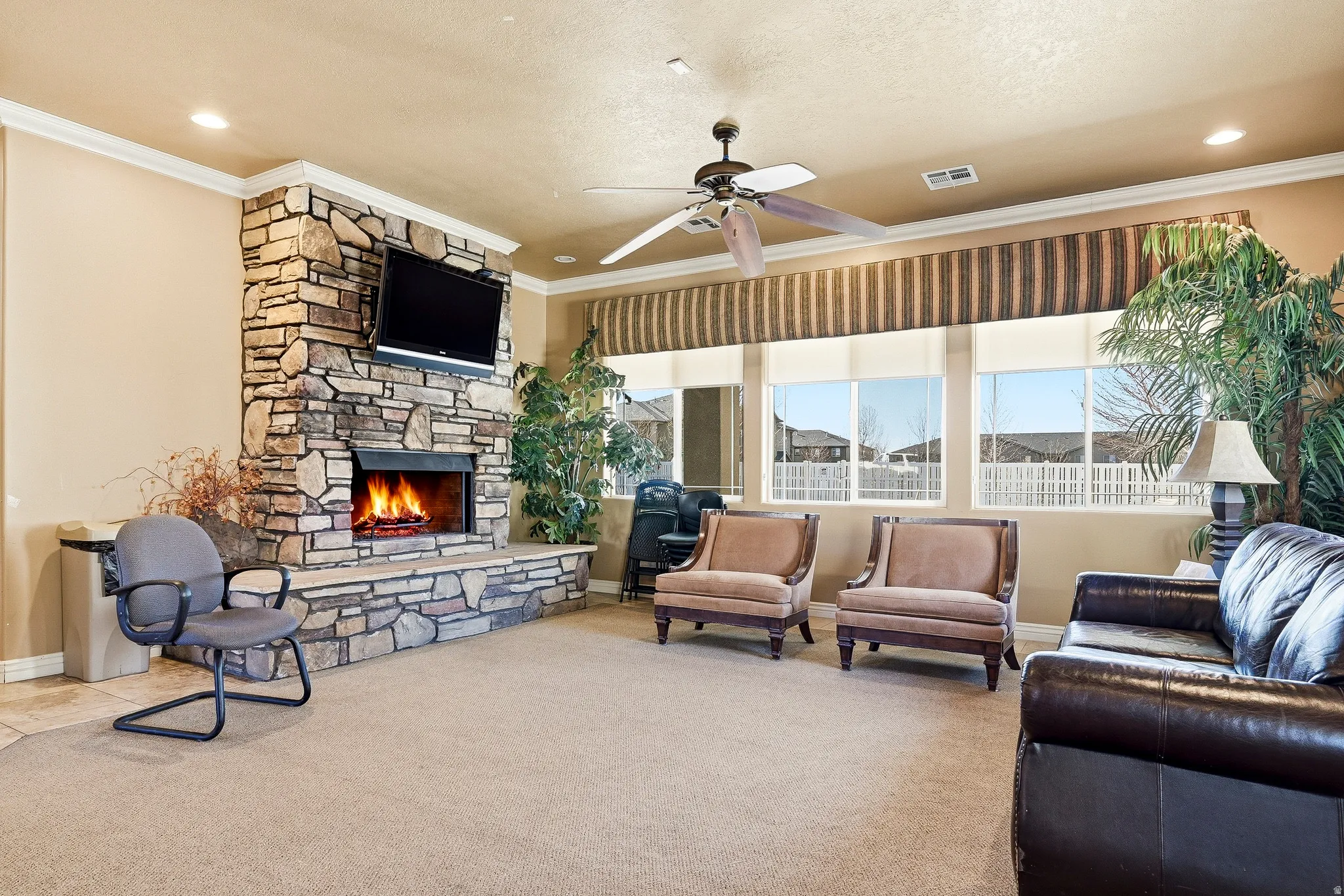 Stone-clad fireplace with a built-in hearth and television mount