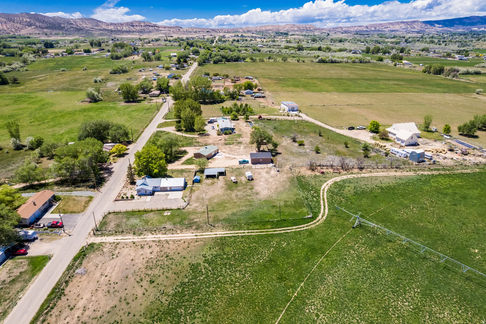 Expansive rural setting featuring verdant fields and distant mountains