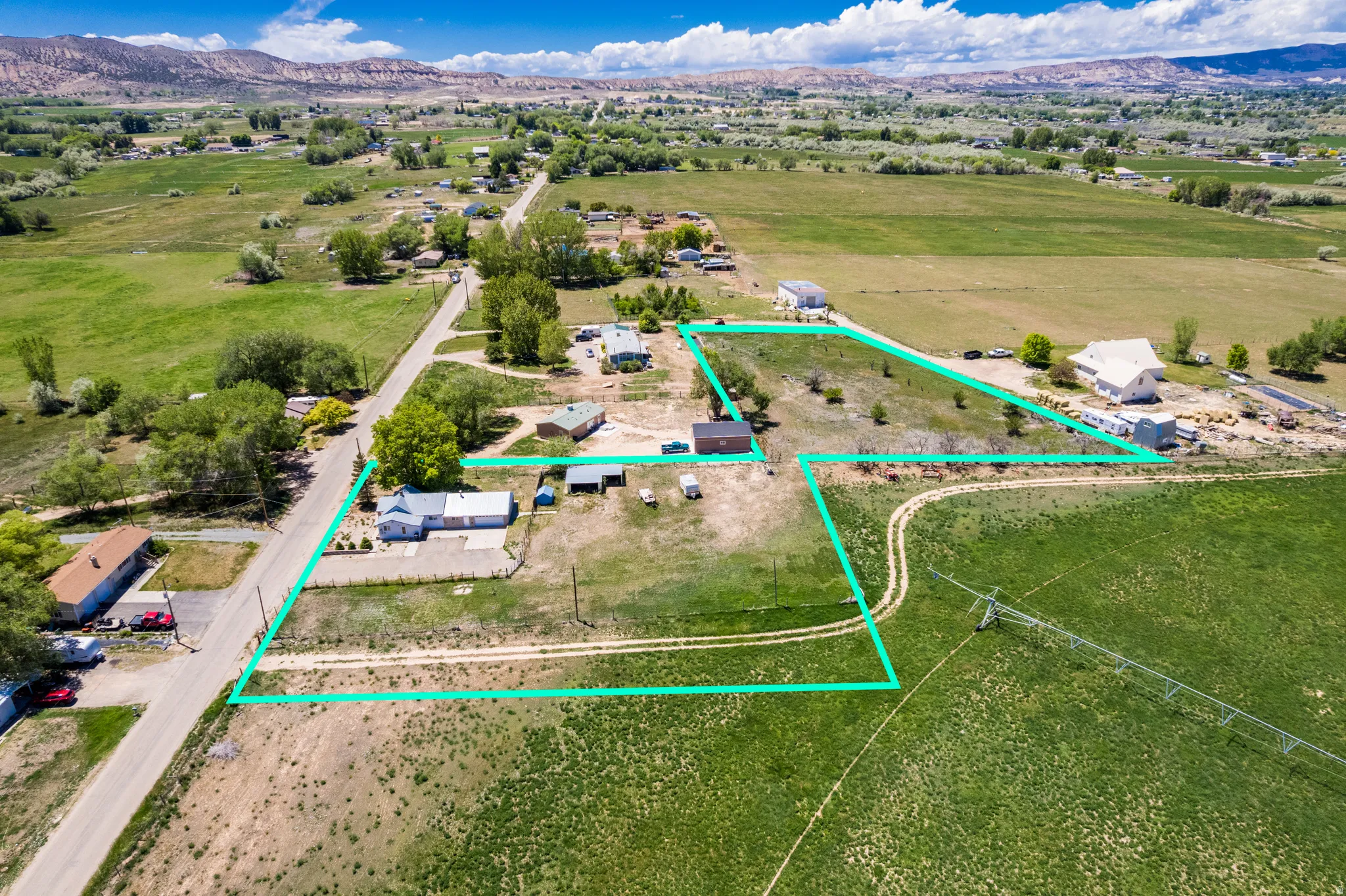 Expansive property featuring multiple structures and open land