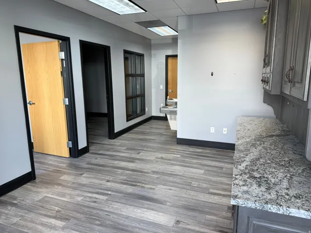 Room featuring wood-finish flooring and light gray walls