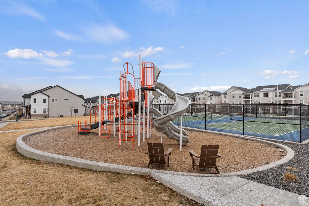 Community playground featuring a multi-level play structure with slides and climbing elements