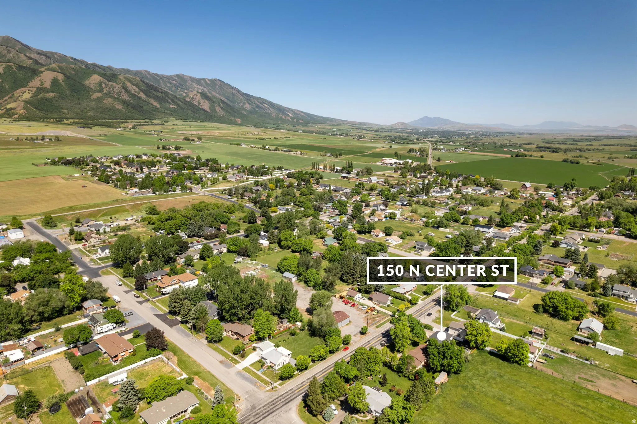 Aerial overview of a residential area set against a mountainous backdrop