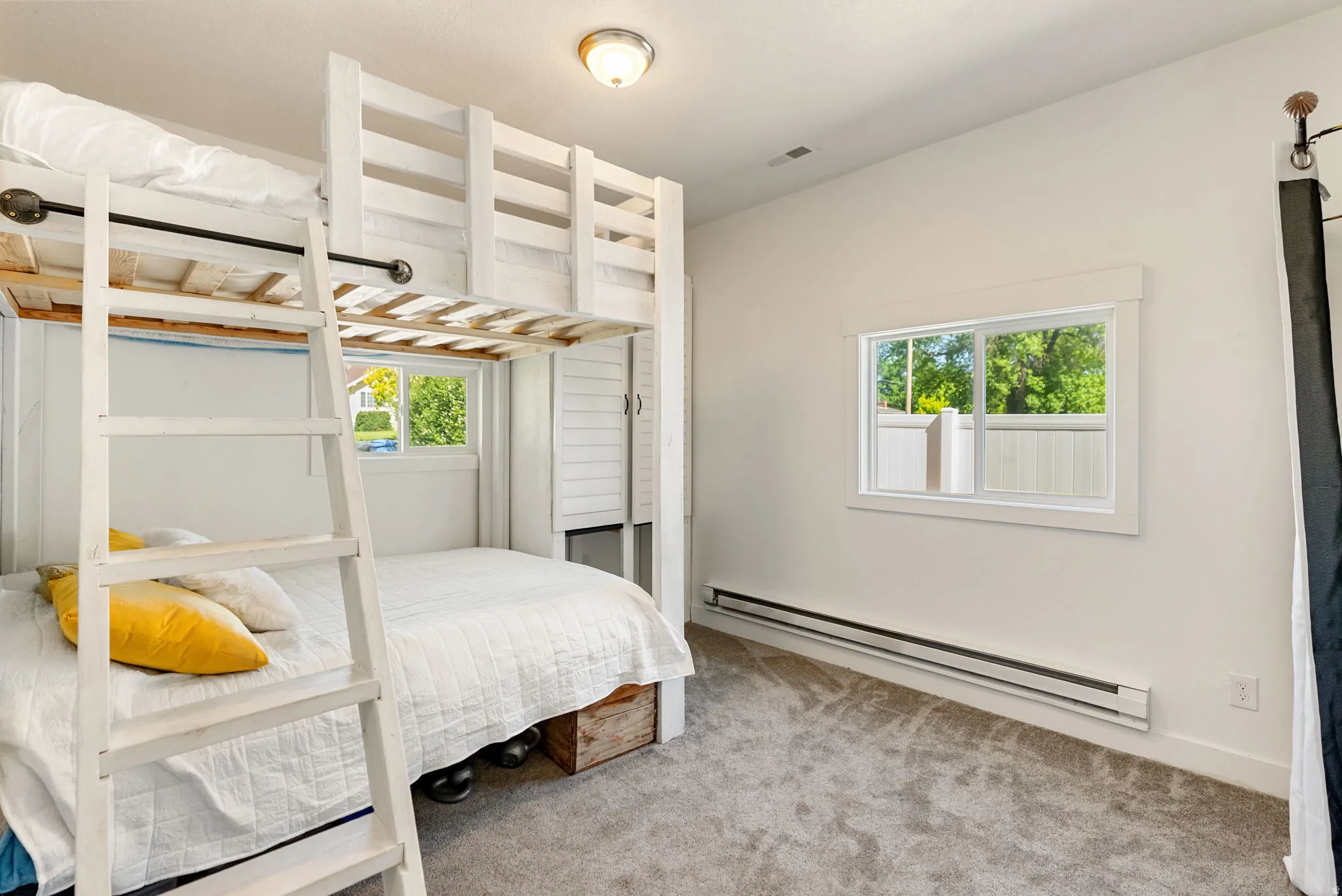 Room featuring a built-in bunk bed structure with a white finish, carpet flooring, and white walls