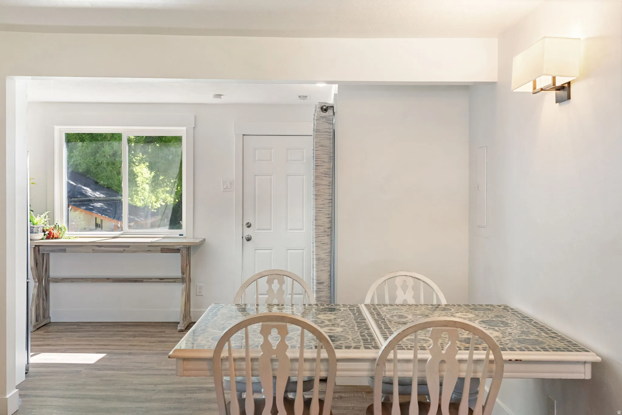 Interior space featuring wood-finish flooring, white walls, and a white interior door