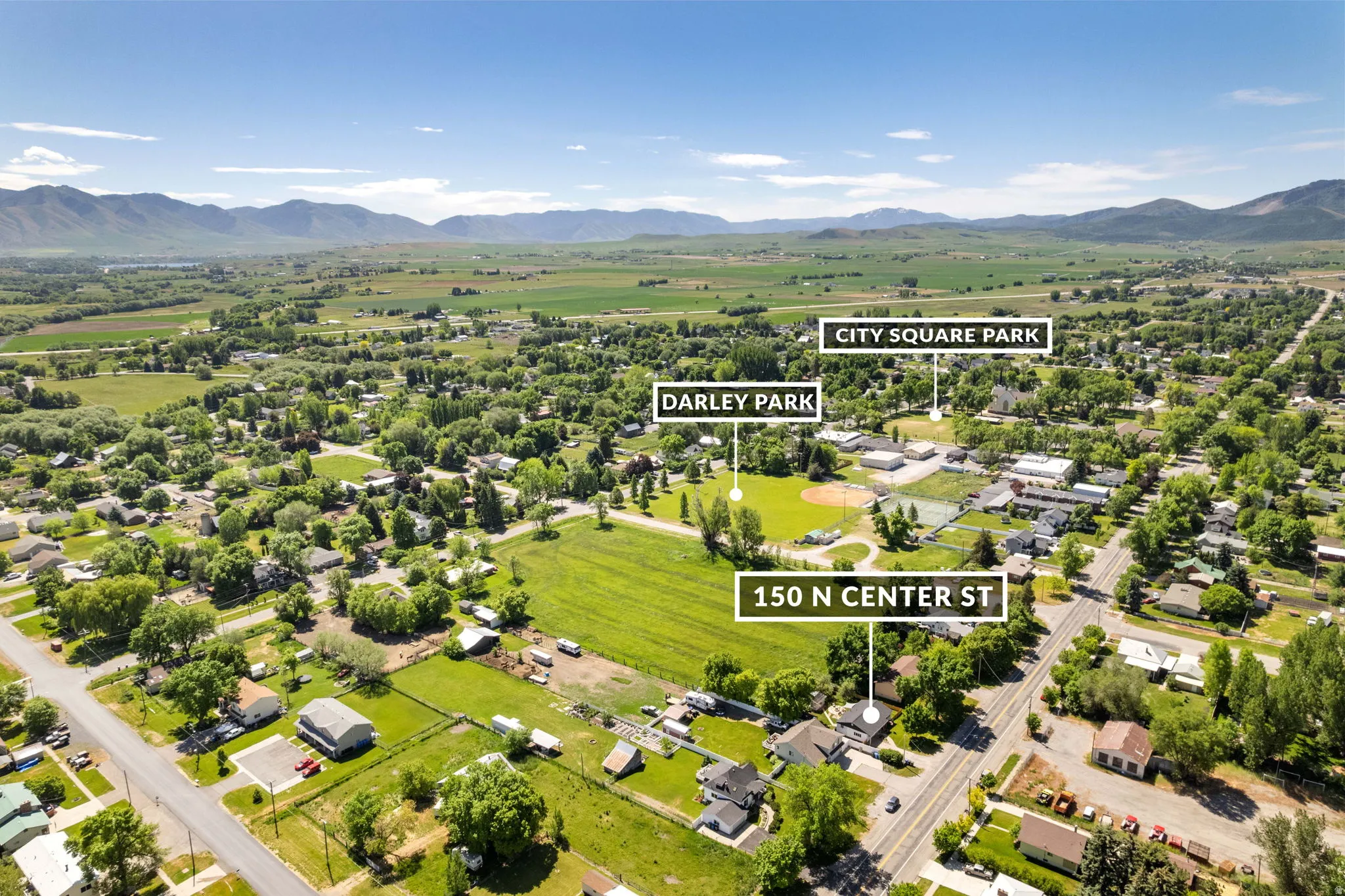 Aerial perspective showcasing the property's setting amidst residential areas and open green spaces