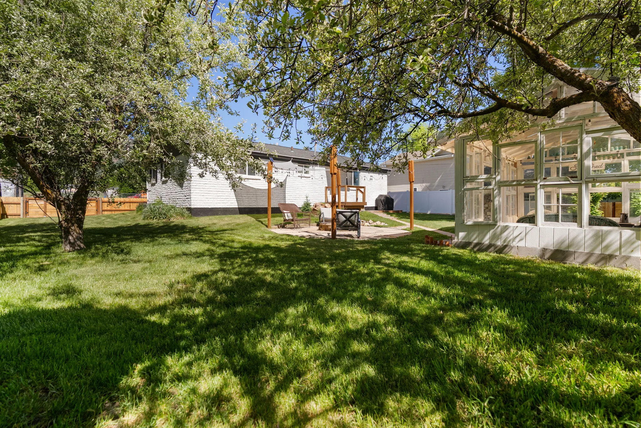 Spacious backyard with a vibrant green lawn