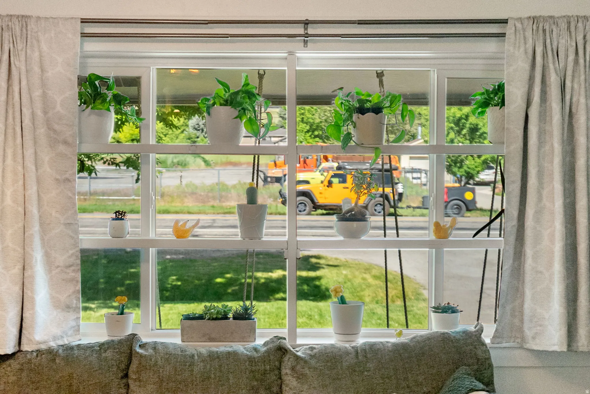 Expansive multi-pane window with white framing and integrated shelving
