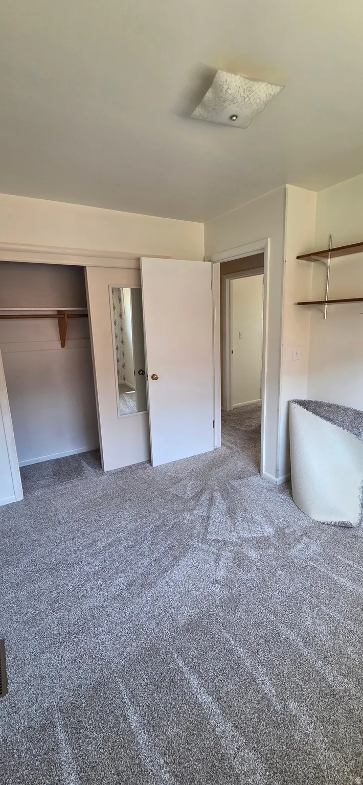 Neutral-toned wall-to-wall carpeting with a subtle pattern