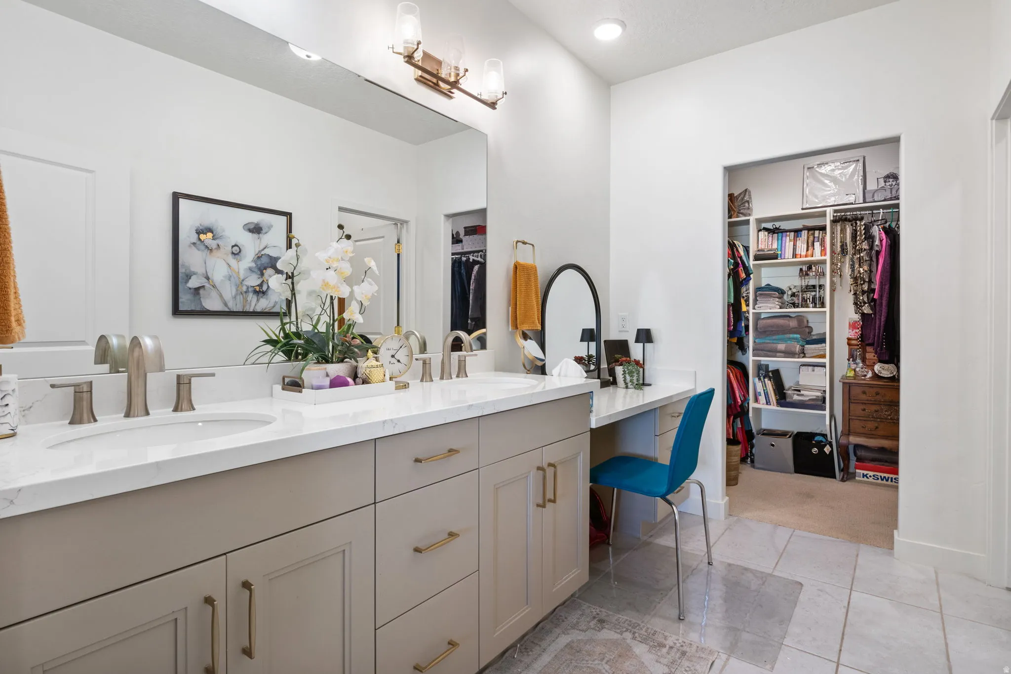 Dual vanity with integrated sinks and brushed nickel faucets, set into a light-toned countertop
