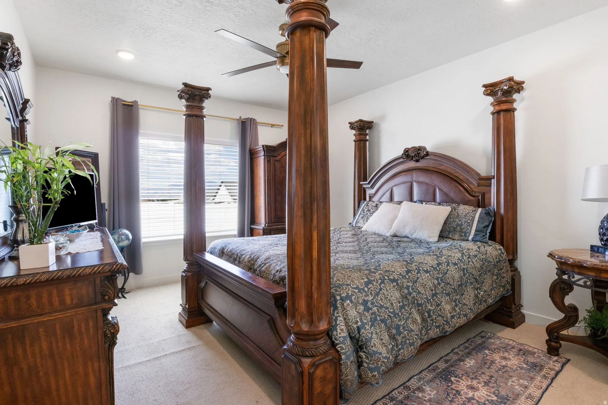 Carpeted room featuring a ceiling fan with light, recessed lighting, and a window with blinds