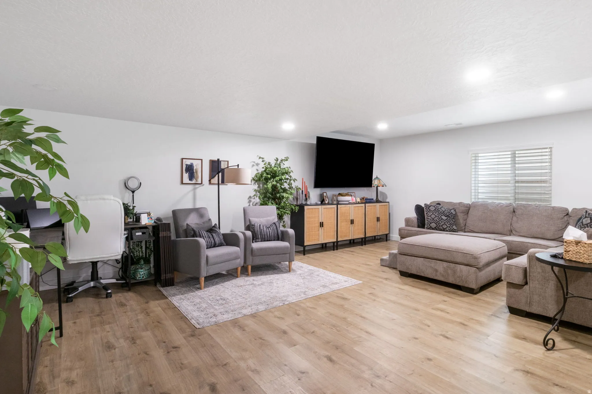 Open concept living space featuring wood-finish flooring and recessed lighting