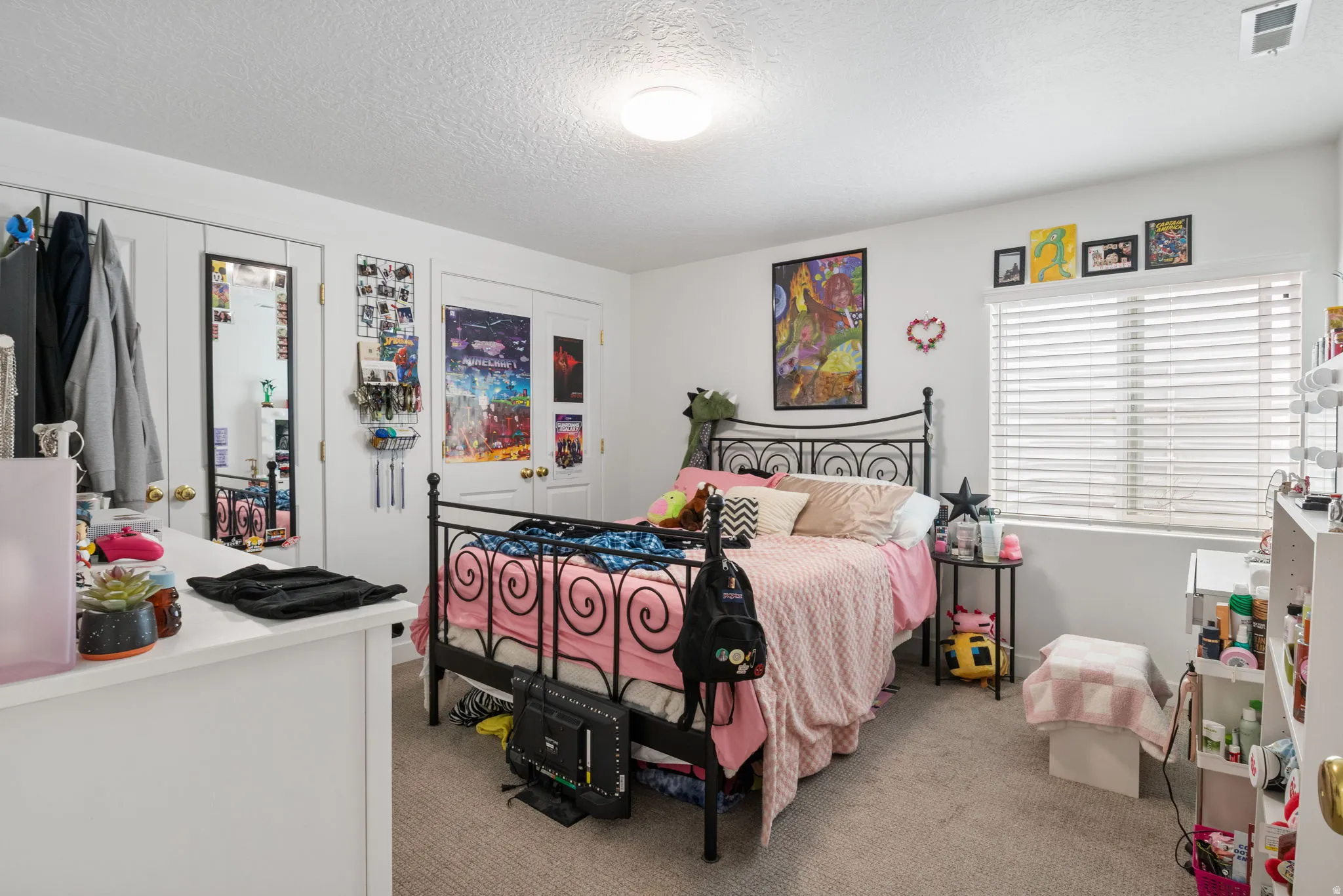 Bedroom featuring carpeting, a window with horizontal blinds, and a flush mount ceiling light