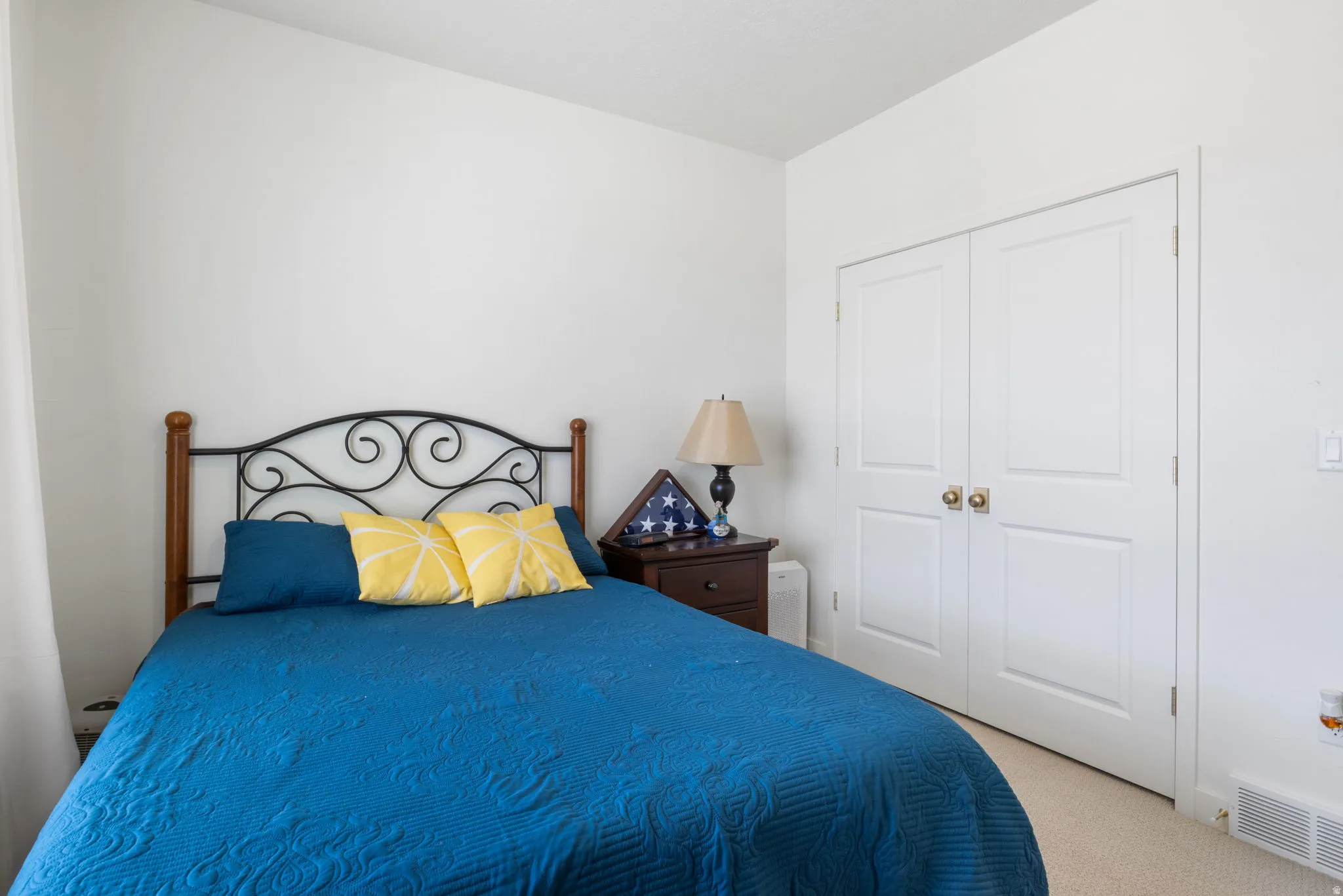 Bright interior space featuring a double-door closet with polished brass hardware