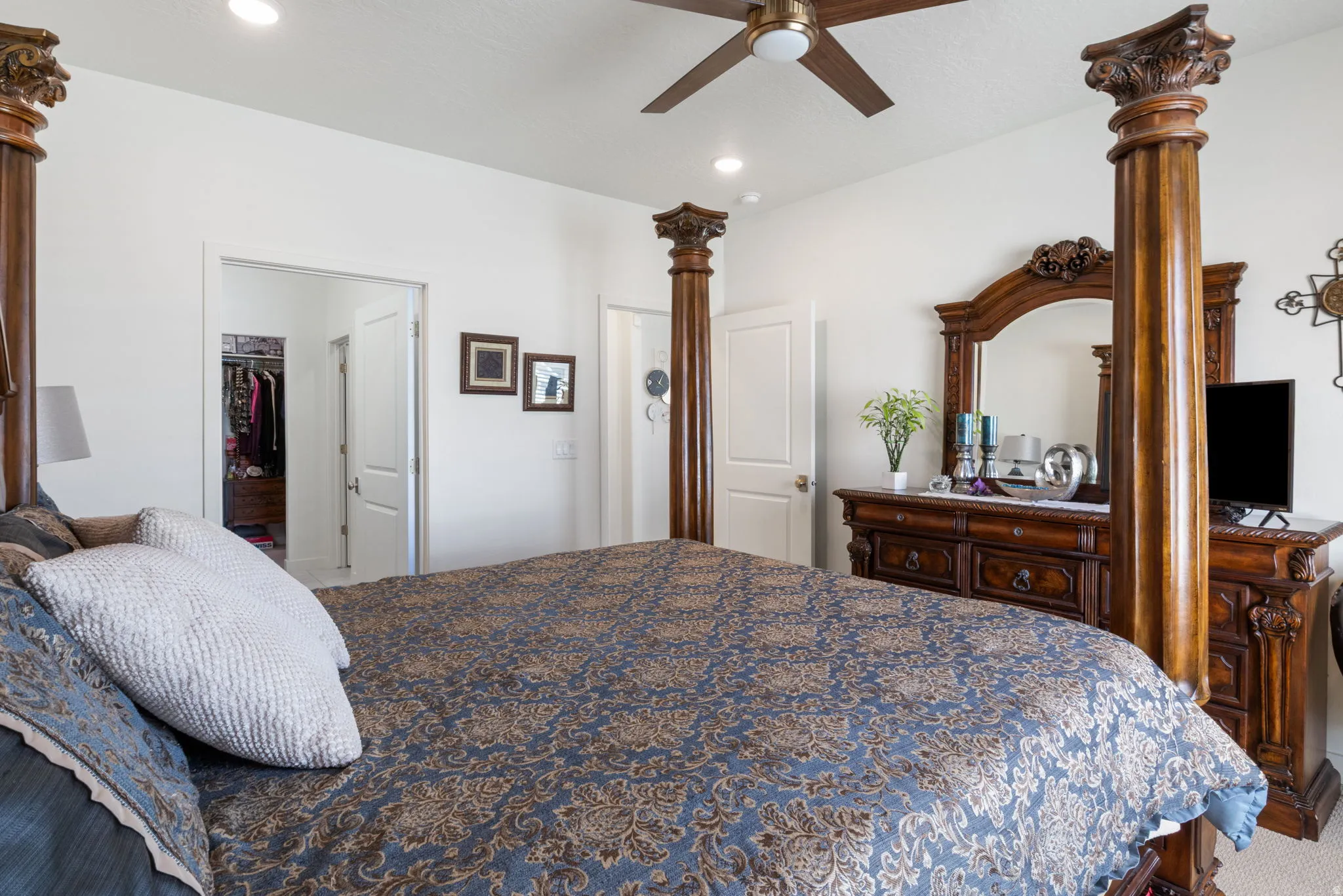 Bright bedroom featuring a ceiling fan, recessed lighting, and a closet with a bifold door