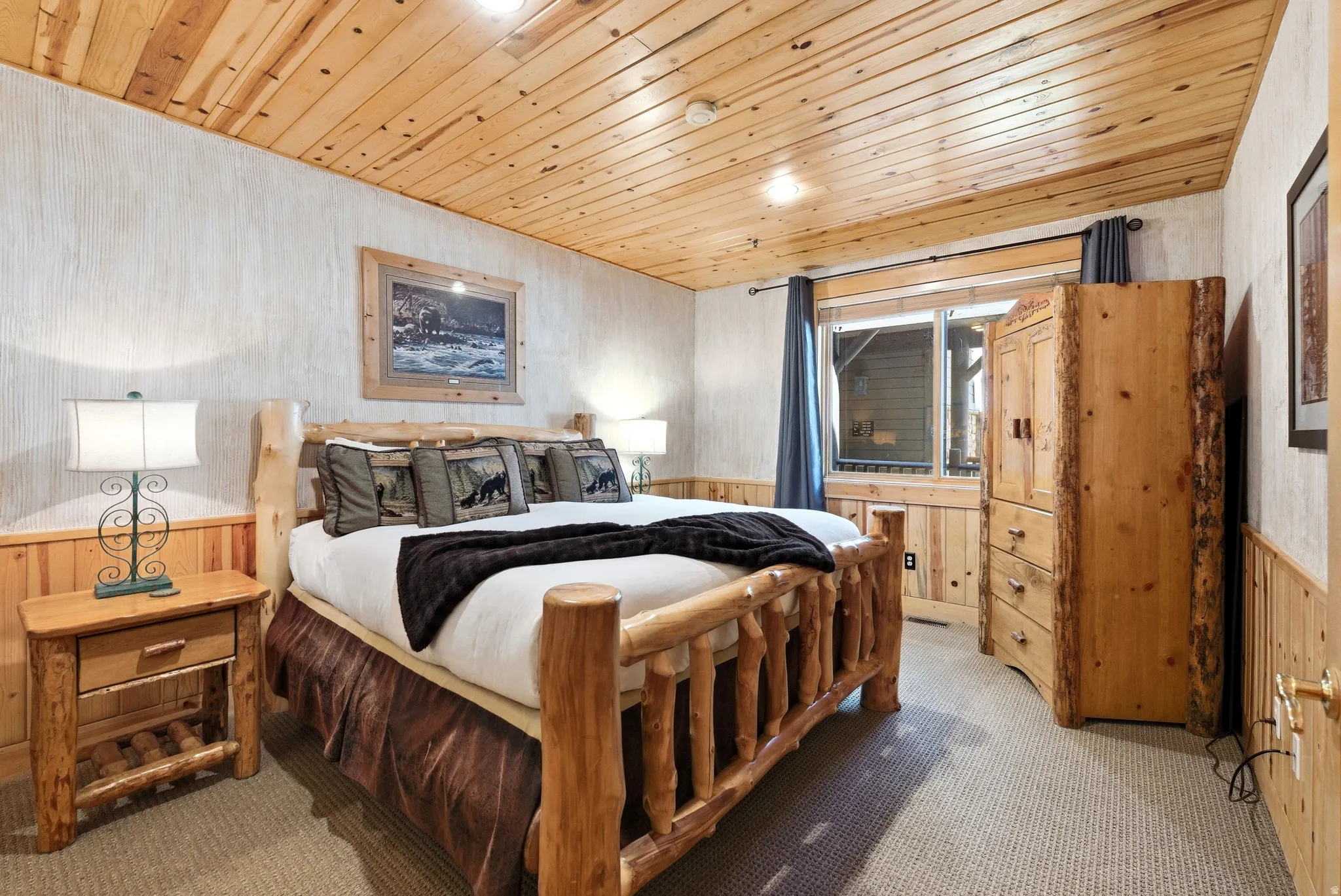 Wood-paneled ceiling and wainscoting frame this room, featuring textured wall finishes