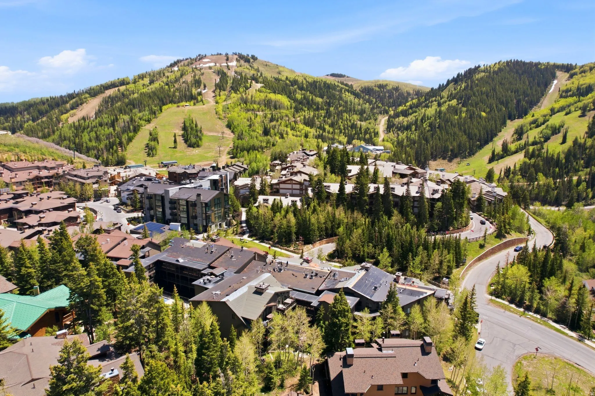 Mountain resort community featuring extensive forest coverage and winding roads