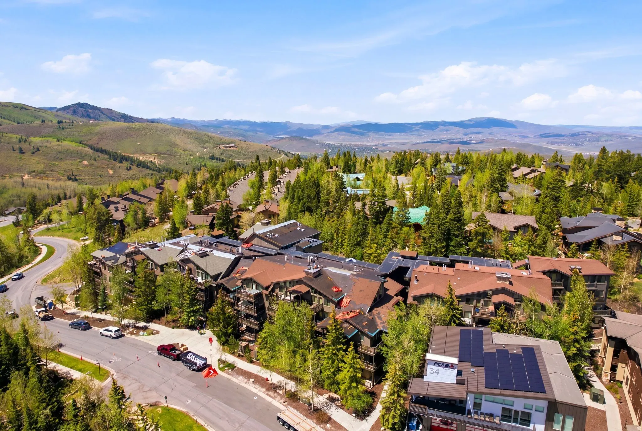 Mountainous landscape featuring residential architecture and abundant tree coverage