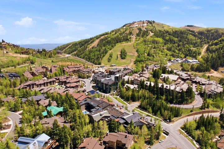 Aerial perspective highlighting a mountain community with surrounding ski slopes and lush tree coverage