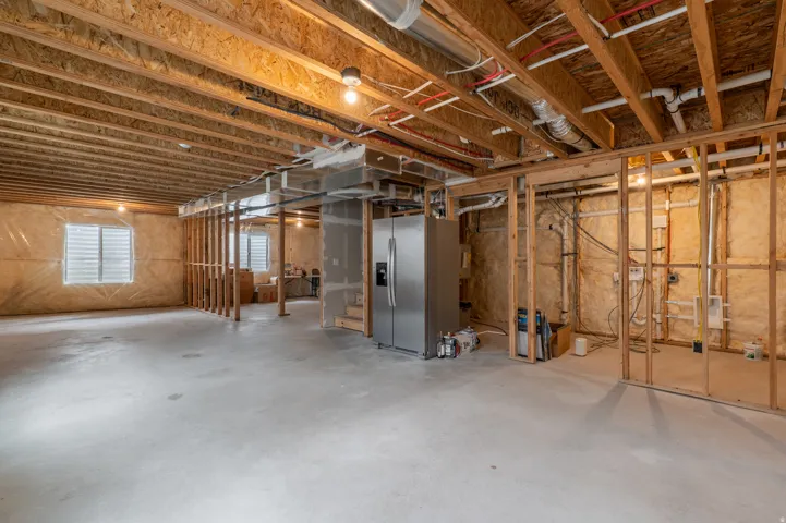 Spacious unfinished basement offering significant potential for customization