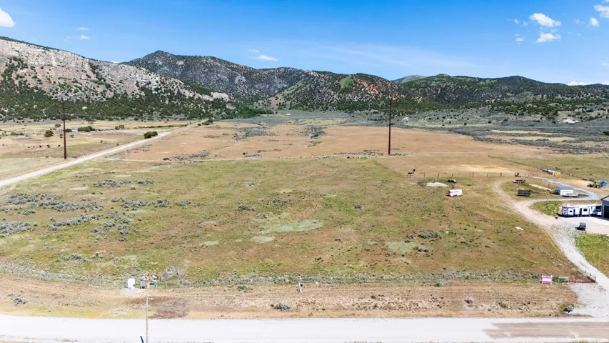 Expansive land parcel featuring natural ground cover and distant mountain range