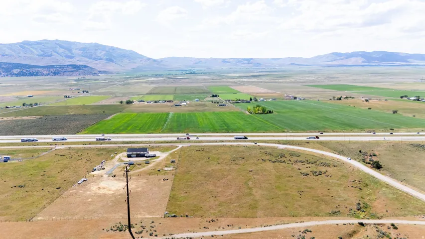Expansive rural landscape featuring distant mountains and agricultural fields