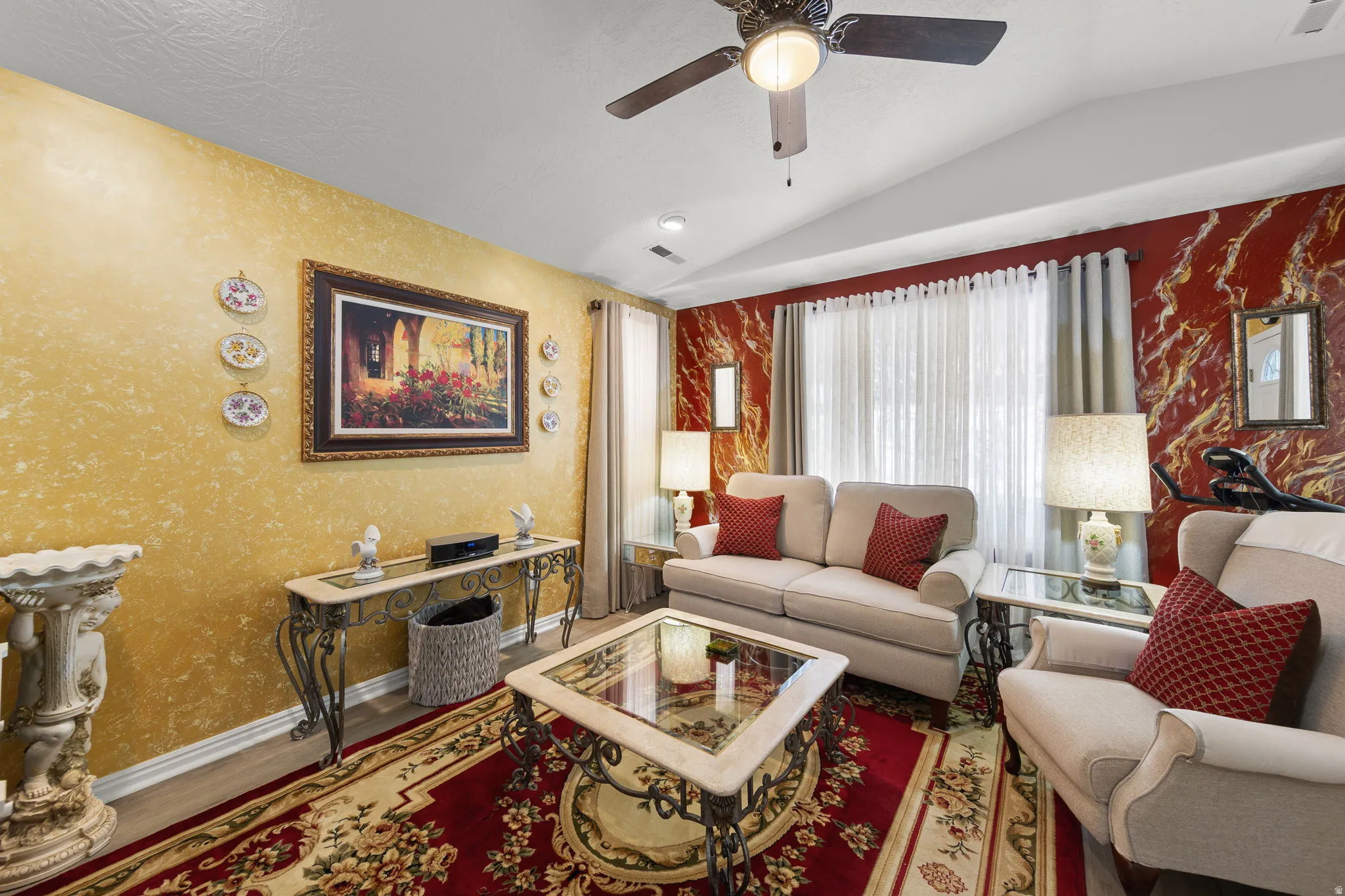 Living space featuring a vaulted ceiling with a ceiling fan