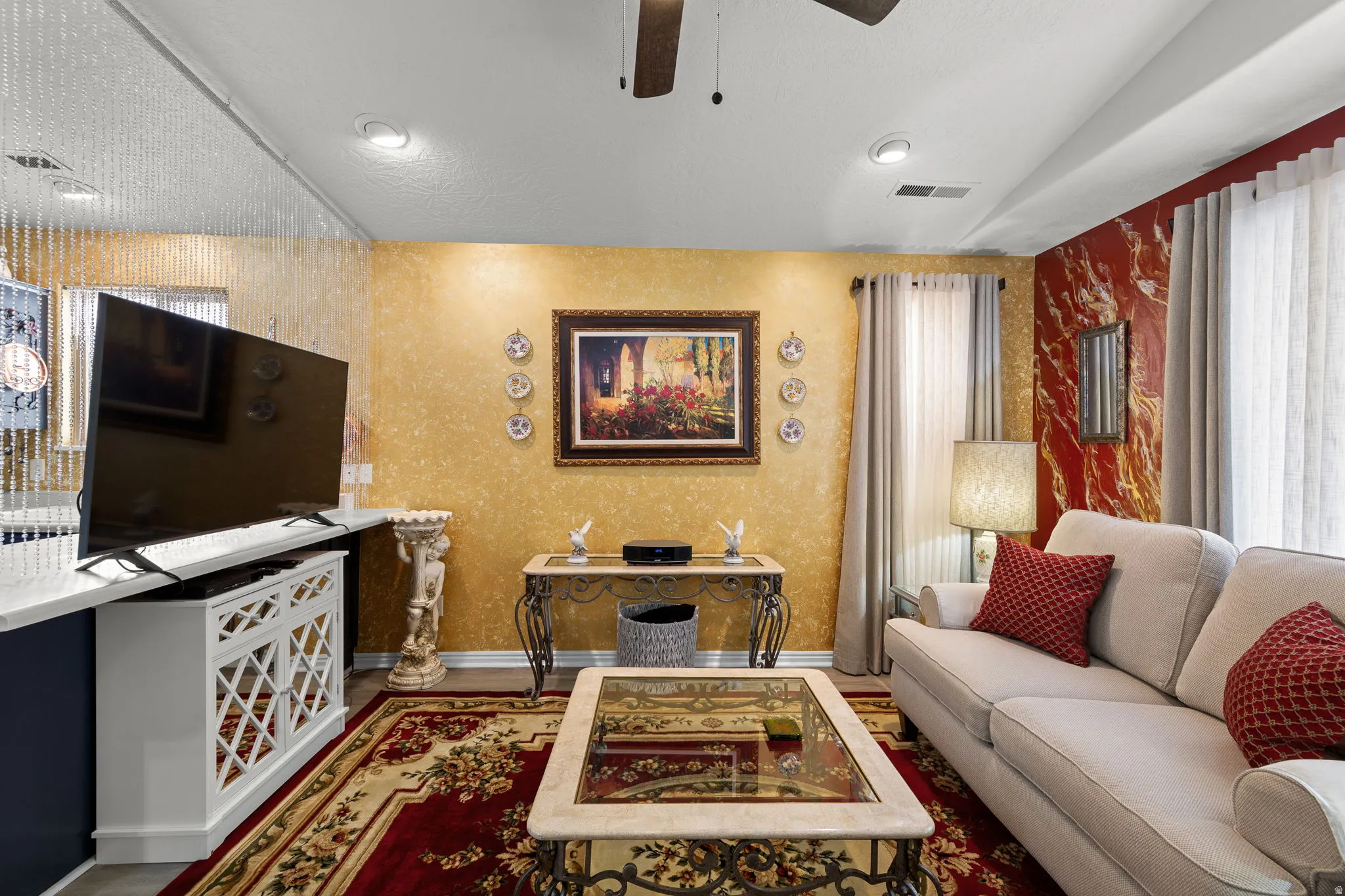 Living area featuring recessed lighting, a ceiling fan, and decorative wall finishes