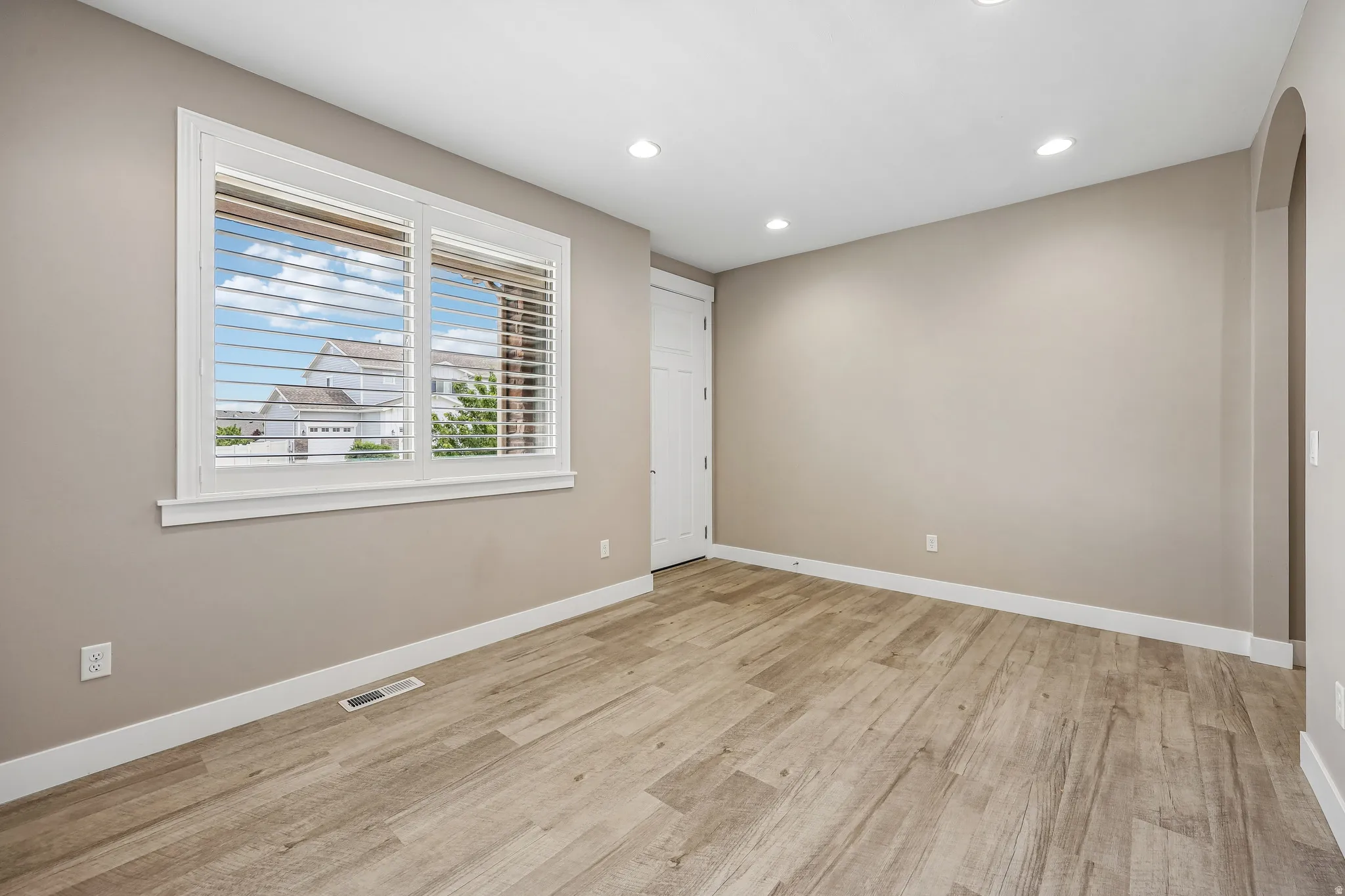 Interior room featuring wood-finish flooring and recessed ceiling lighting