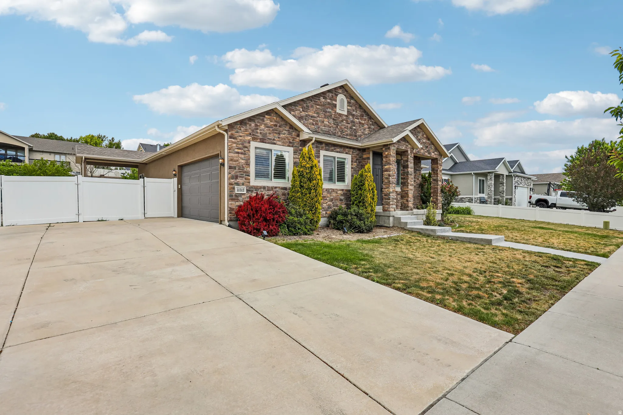 Stone and stucco exterior with a covered porch entry