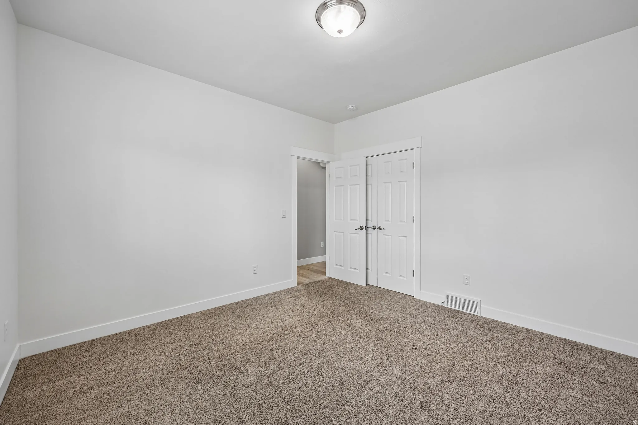 Neutral-toned carpeting paired with white walls