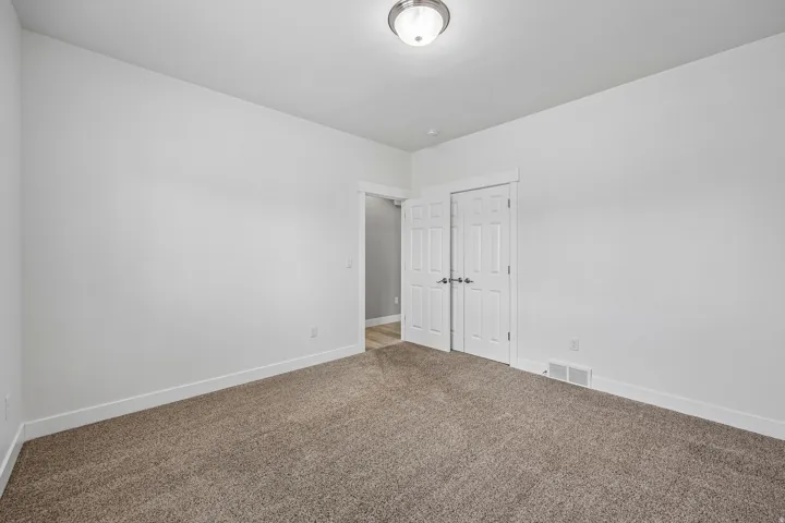 Neutral-toned carpeting paired with white walls