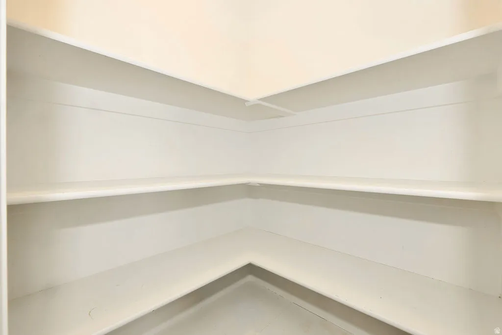 Corner built-in shelving with multiple storage levels and a neutral finish