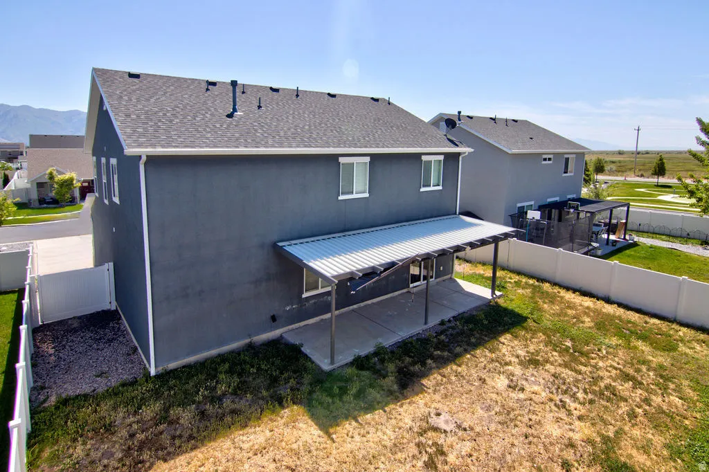 Two-story residence featuring a dark gray stucco exterior and white trim