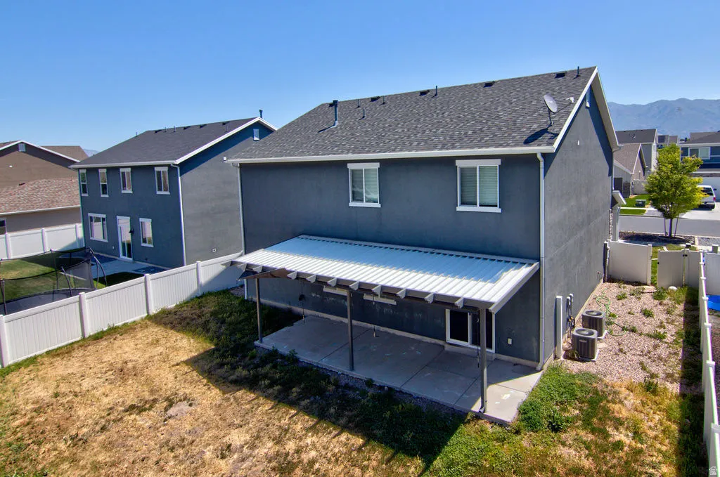 Two-story stucco exterior featuring a dark gray roof