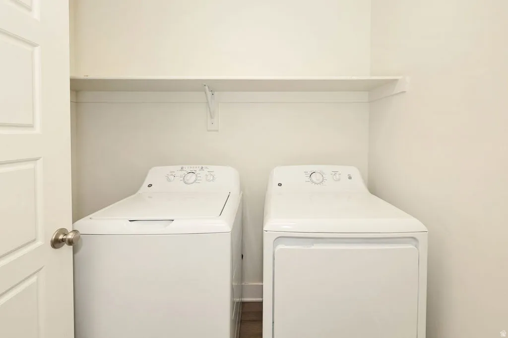 Dedicated laundry area featuring a built-in top shelf and a paneled door