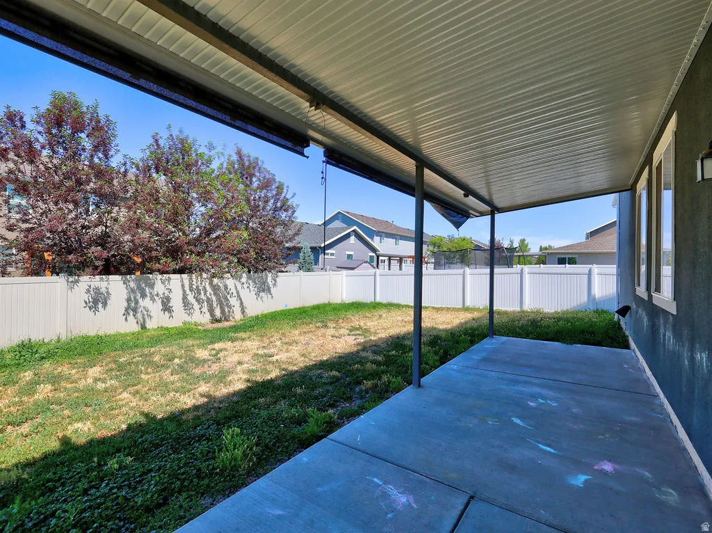 Covered patio featuring a solid roof structure and concrete flooring