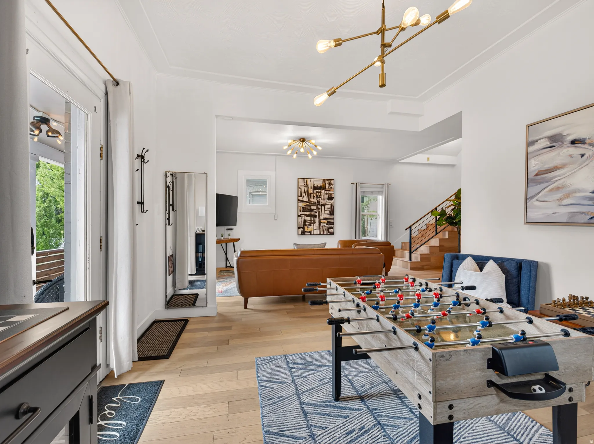 Open-concept living space with light wood-finish flooring