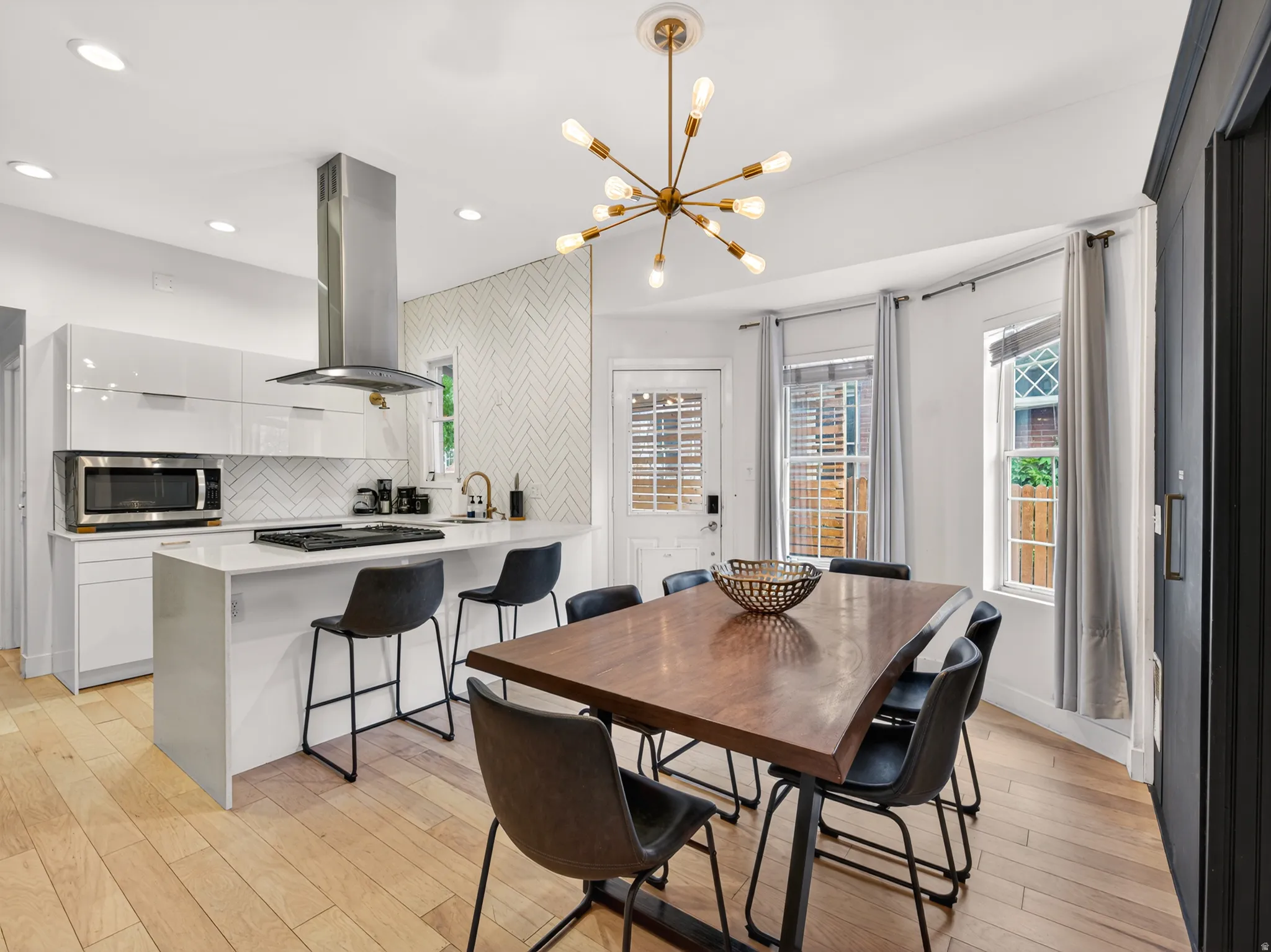 Open-concept kitchen and dining area featuring light wood-finish flooring