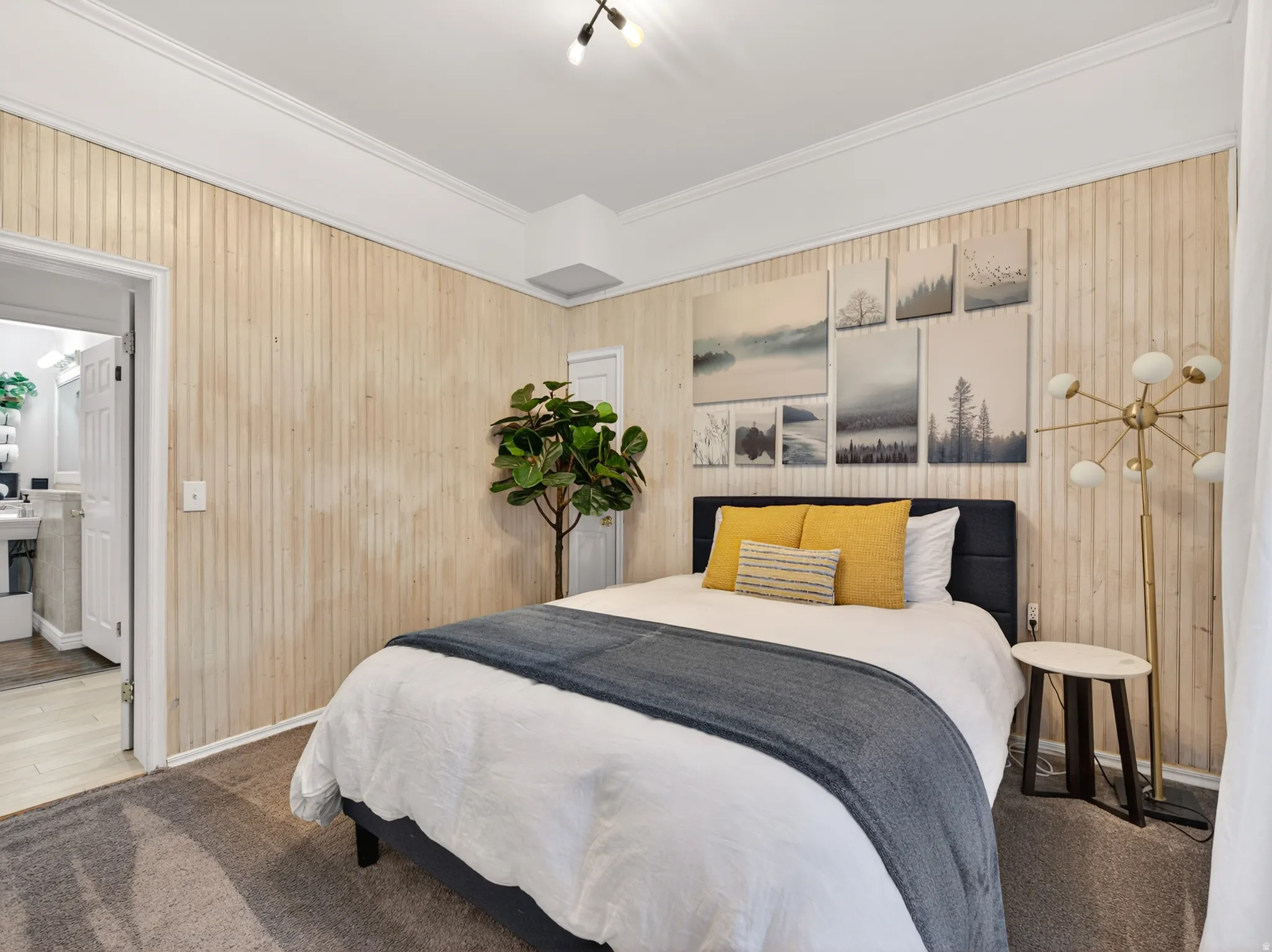 Interior room featuring light-toned vertical wood paneling, crown molding, and recessed lighting