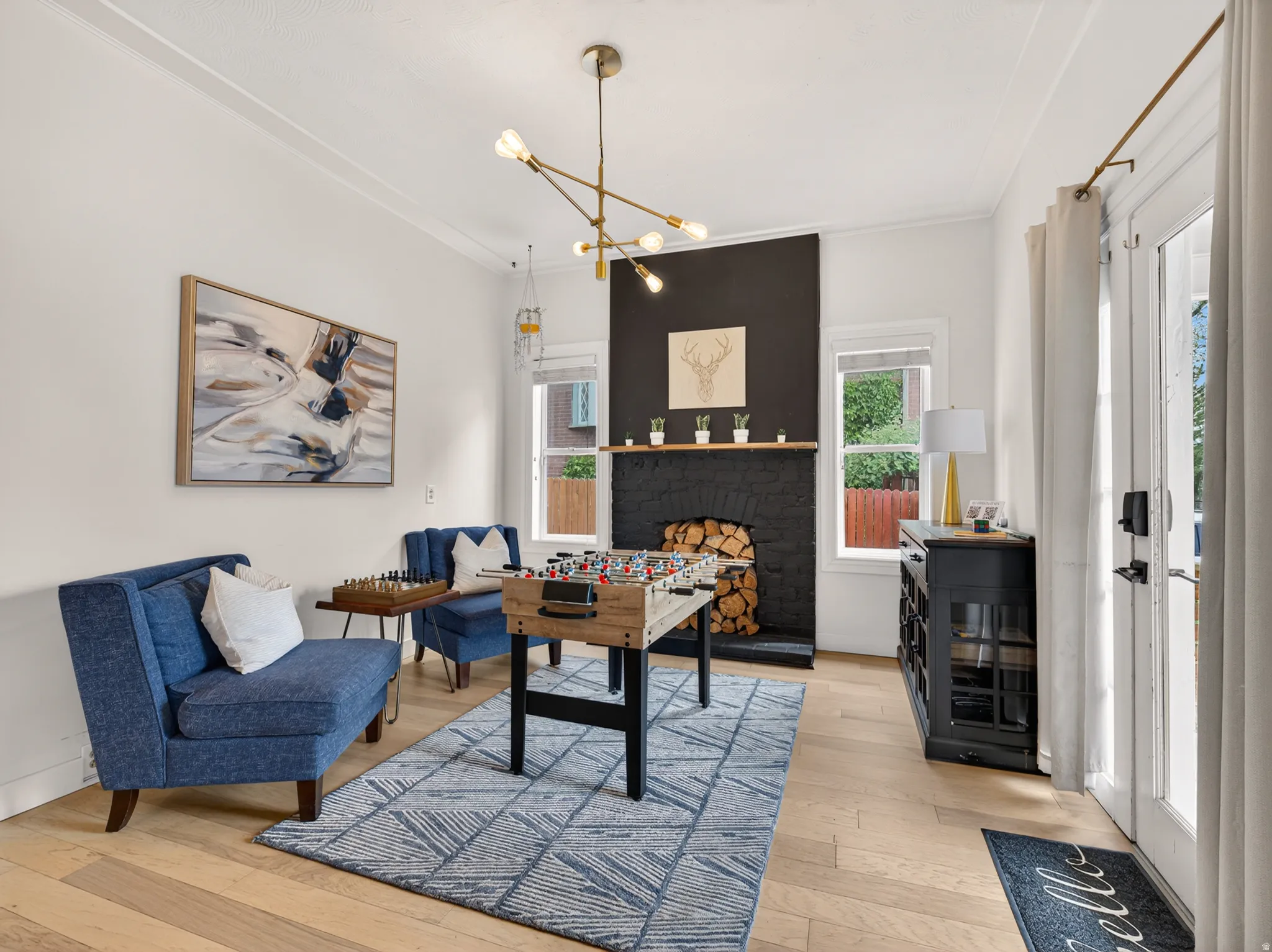 Light wood-finish flooring complements a dark accent fireplace